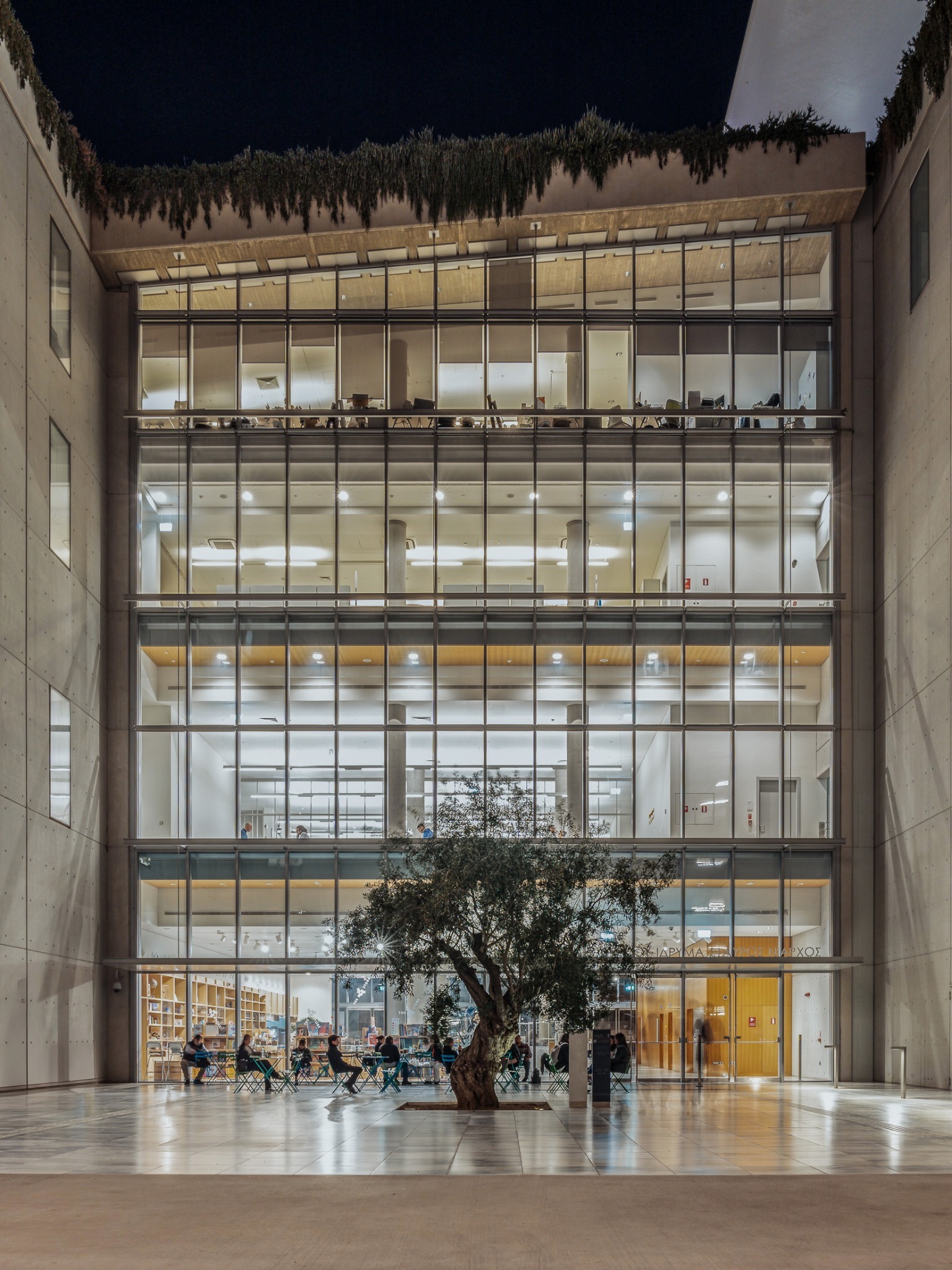 Stavros Niarchos Foundation Cultural Center — illuminated atrium and tree at night