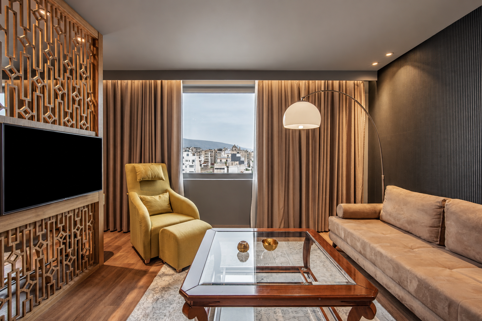 Wyndham Athens — lounge with TV and armchair, photograph 3