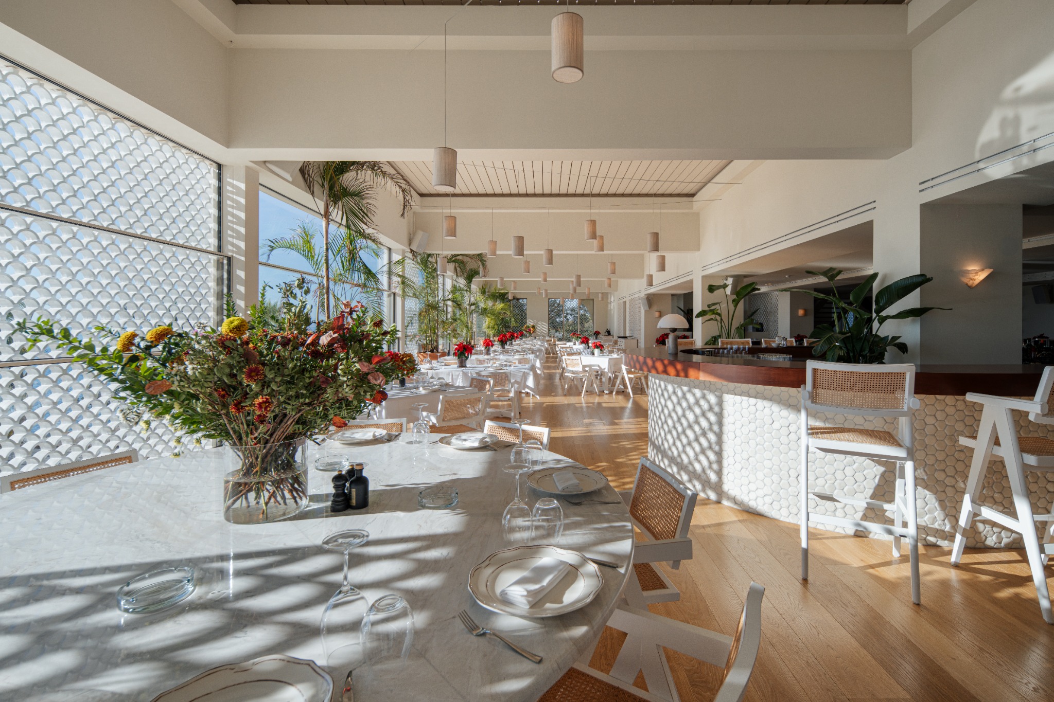 Sea Satin Athens, Voula — indoor foreground dining table and bar on the right